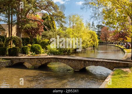 Vista panoramica dei bassi ponti in pietra di Bourton-on-the-Water attraverso il fiume Windrush, una popolare destinazione di Cotswolds, Gloucestershire, Inghilterra, Regno Unito. Foto Stock