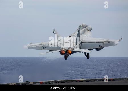 MAR DELLE FILIPPINE (Feb 17, 2022) un F/A-18F Super Hornet, assegnato al 'Black Aces' di Strike Fighter Squadron (VFA) 41, lancia dal ponte di volo della portaerei di classe Nimitz USS Abraham Lincoln (CVN 72). Abraham Lincoln Strike Group è in fase di implementazione pianificata nell'area delle operazioni della flotta USA 7th per migliorare l'interoperabilità attraverso alleanze e partnership, fungendo da forza di risposta pronta a supportare una regione indopacifica libera e aperta. (STATI UNITI Foto Navy di Mass Communication Specialist 3rd Classe Michael Singley) Foto Stock