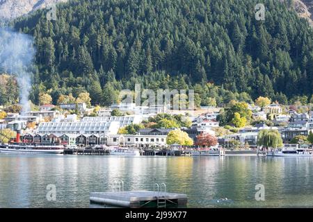 Vista panoramica sulle barche e gli edifici del lago Wakatipu vicino al molo di Queenstown, Nuova Zelanda. Foto Stock