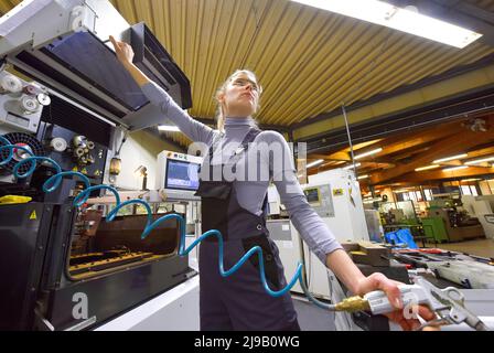 Una tirocinante femminile riceve lezioni tecniche dal suo istruttore. Entrambe le donne lavorano come ingegneri computerizzati di controllo numerico. Foto Stock