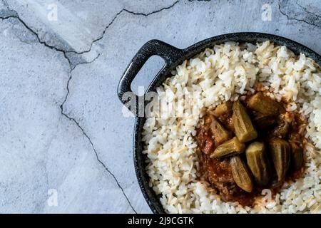 Okra e stufato di carne in una pentola come piatto. Vista dall'alto, spazio di copia Foto Stock