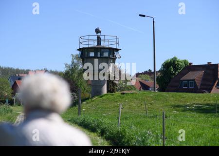 PRODUZIONE - 09 maggio 2022, Sassonia-Anhalt, Hötensleben: Testimone contemporaneo Gitta Kappe cammina davanti a un'ex torre di guardia al 'Monumento al confine di Hötensleben'. Il confine è stato chiuso proprio come Gitta Kappe era sul lato sbagliato per lei. Il 26 maggio 1952, l'allora 20 anni era al lavoro a Schöningen nella FRG; come bambina e cameriera, era il buon spirito nella famiglia di un medico. Ha sempre percorso la sua bicicletta per i quattro chilometri alla sua città natale di Hötensleben, l'ormai 90 anni ricorda. A casa, quella era i suoi genitori e la sua fidanzata. Foto: Klaus-Dietmar Gabbert/dpa Foto Stock