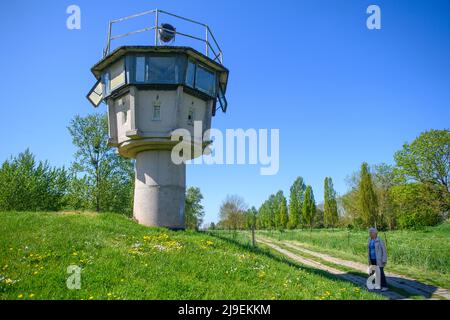 PRODUZIONE - 09 maggio 2022, Sassonia-Anhalt, Hötensleben: Testimone contemporaneo Gitta Kappe si trova al 'Hötensleben Border Monument' di fronte ad una ex torre di guardia. Il confine è stato chiuso proprio come Gitta Kappe era sul lato sbagliato per lei. Il 26 maggio 1952, l'allora 20 anni era al lavoro a Schöningen nella FRG; come bambina e cameriera, era il buon spirito nella famiglia di un medico. Ha sempre percorso la sua bicicletta per i quattro chilometri alla sua città natale di Hötensleben, l'ormai 90 anni ricorda. A casa, quella era i suoi genitori e la sua fidanzata. (A dpa 'filo a barbare attraverso la Germania - GDR chiuso confine 70 Foto Stock