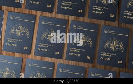 Passaporti dello stato caraibico di New Dominica , vista dall'alto, su un tavolo di legno Foto Stock