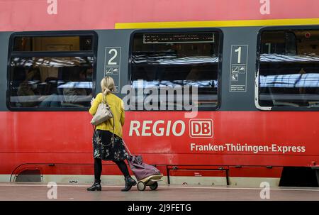 Lipsia, Germania. 23rd maggio 2022. Una donna cammina lungo un treno regionale espresso alla stazione centrale di Lipsia. La gente in Sassonia potrà acquistare il biglietto da 9 euro per i mezzi pubblici a partire da lunedì. Il biglietto è di solito disponibile presso distributori automatici, punti vendita o autisti di autobus e sarà valido in tutta la nazione a partire da giugno 1. Credit: Jan Woitas/dpa/Alamy Live News Foto Stock