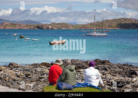Isola di Iona, Inner Hebrides, Scozia, Regno Unito. 23rd maggio 2022. Pomeriggio soleggiato dopo la mattina pioggle, temperatura che sale a 18 gradi a metà pomeriggio, leggero beze mantenere a bada midges. Nella foto: La famiglia ha un piacevole pic-nic con una bella vista su Sound of Iona. Credit: Arch White/Alamy Live News. Foto Stock