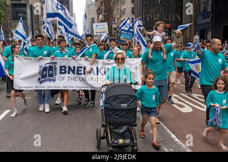 New York, US, 22/05/2022, i partecipanti che detengono bandiere israeliane marciano lungo la Fifth Avenue durante la Felebrate Israel Parade a New York City. Il JCRC-NY celebra la Parata d'Israele è la più grande espressione di solidarietà con lo Stato ebraico al mondo. Unisciti a noi e fai il tifo per più di 40.000 marchers, decine di favolosi carri allegorici, gruppi di marching e alcuni eccitanti artisti ebrei e israeliani! La sfilata procede fino alla Fifth Avenue da 57th Street a 74th Street, mostrando passione per lo Stato di Israele e amore per la comunità ebraica globale. Foto Stock