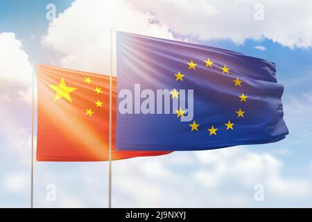 Cielo azzurro soleggiato e bandiere dell'Unione europea e della cina Foto Stock