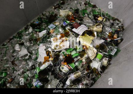 Bucarest, Romania - 25 maggio 2022: Rifiuti di vetro triturati da una macchina e pronti per essere riciclati. Foto Stock