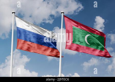 Russia e Maldive due bandiere su flagpoli e sfondo blu cielo nuvoloso Foto Stock