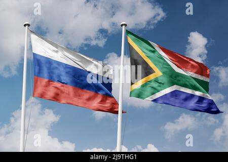 Russia e Sud Africa due bandiere su flagpoli e sfondo blu cielo nuvoloso Foto Stock