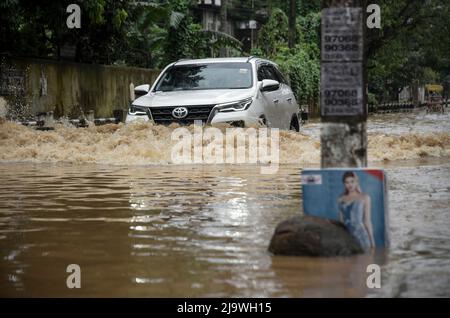 Guwahati, Assam, India. 25th maggio 2022. Un'auto attraversa una strada allagata dopo forti piogge, a Guwahati, Assam, India, il 25 maggio 2022. Il waterlogging è una scena comune nella città di Guwahati a causa del sistema di drenaggio povero. Credit: David Talukdar/Alamy Live News Foto Stock