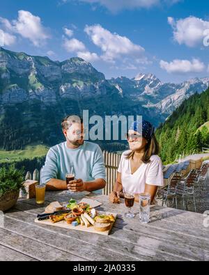 Coppia uomini e donne in vacanza nella scogliera delle Alpi Svizzere Aescher vista dalla montagna Ebenalp nella regione di Appenzell in Svizzera Foto Stock