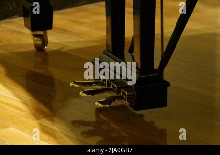 Pedale morbido, pedale della marmitta e pedale dell'ammortizzatore di una Steinway e Sons Grand piano su un pavimento in legno. Foto Stock