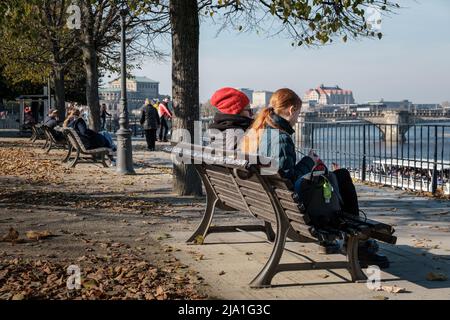 Diverse persone seduti su una panchina e guardando dalla terrazza al fiume Elba nella città di Dresda. Foto Stock