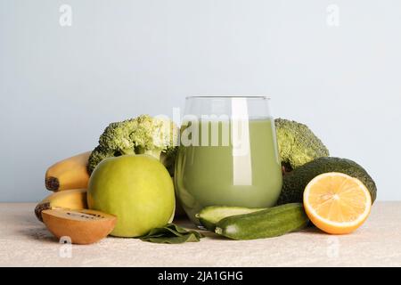 Frullato verde fresco in vetro con verdure su sfondo blu. Cibo vegano, lifestyle sano.sano detox dieta copia spazio Foto Stock