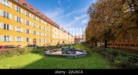 Cortile interno con parco e appartamenti gialli, Borstei, patrimonio immobiliare protetto, quartiere Moosach, Monaco, Baviera, Germania Foto Stock