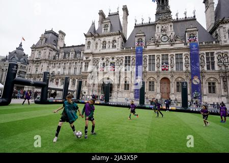 I bambini giocano su un mini pitch al Trophy Epierence presso Place de l'Hotel de Ville a Parigi, davanti alla finale della UEFA Champions League di sabato allo Stade de France di Parigi. Data foto: Venerdì 27 maggio 2022. Foto Stock