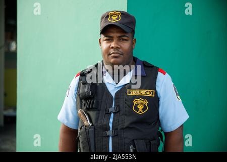 2022.12.03 Province della Repubblica Dominicana la Altagracia. Una guardia di sicurezza maschile munita di una pistola. Popolo dominicano. Foto Stock