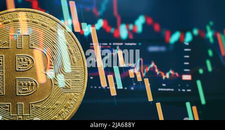 Bitcoins oro con candela stick diagramma grafico e sfondo digitale. Foto Stock