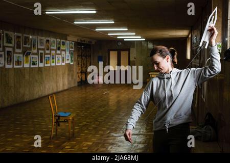 Uzhhorod, Zakarpattia, Ucraina. 30th Mar 2022. Julia Malik, di solito un insegnante di storia in una scuola locale, tesse una rete che più tardi coprirà armatori camion dell'esercito ucraino a Uzhhorod.non solo al suo interno sfollati ucraini, ma anche locali volontari in molti ruoli diversi per aiutare il loro paese a vincere la guerra. Potrebbe essere fare reti per le linee anteriori o altri strumenti, insegnare le lingue o organizzare attività per i bambini, lavare i piatti in una cucina comune o prendere forniture per le aree più colpite, ma la maggior parte di loro vogliono contribuire nel modo in cui possono allo sforzo di guerra. SNC Foto Stock