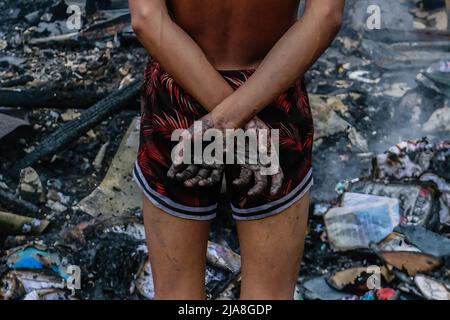 Taytay, Filippine. 28th maggio 2022. Una vittima di un incendio si trova all'interno di macerie durante il periodo successivo. Un incendio che iniziò intorno al 3pm colpì Bato-bato 2 a Barangay Dolores, zone residenziali e lasciò centinaia di persone senzatetto. Il Bureau of Protection delle Filippine sta ancora indagando sulla causa dell'incendio. Credit: SOPA Images Limited/Alamy Live News Foto Stock