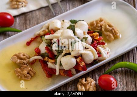 Formaggio per la colazione preparato appositamente. Uno speciale piatto di formaggi preparato con olio d'oliva, verdure, noci e formaggi. Primo piano Foto Stock