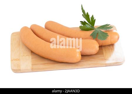 salsicce crude su un asse di legno Foto Stock