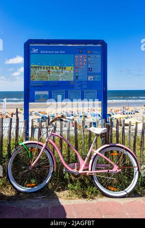 Bicicletta parcheggiata contro un cartello posto sulla spiaggia di Zandvoort aan Zee, Paesi Bassi - 8 agosto 2013 Foto Stock