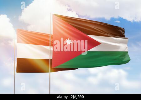 Cielo azzurro soleggiato e bandiere di giordania e yemen Foto Stock