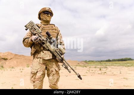 Militari speciali equipaggiati e armati soldato nel deserto. Foto Stock