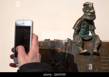 Tula, Russia. 28th maggio, 2022. Un turista fotografa il genere di scultura 'Tula Artisan' sulla strada pedonale Metallist Street nel centro della città provicial di Tula, Russia Foto Stock