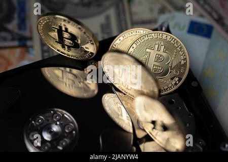 Bitcoin che si riflette sul disco rigido. Concetto di estrazione della valuta Crypto, tecnologia a catena di blocchi e concetto di archiviazione della contabilità. Foto Stock