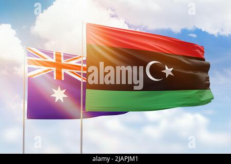 Cielo azzurro soleggiato e bandiere di libia e australia Foto Stock