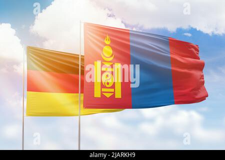 Cielo azzurro soleggiato e bandiere della mongolia e della germania Foto Stock