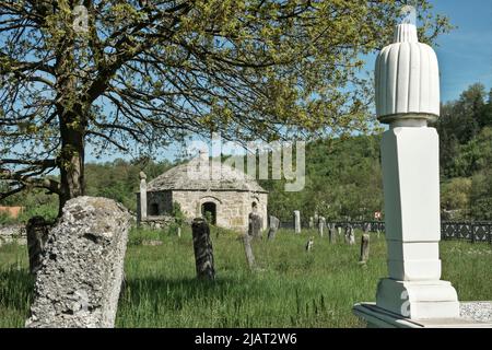 Kopčić, Bugojno, Bosnien und Herzegowina – Maggio 2022: Antico cimitero musulmano con tombe (tartaruga) delle famiglie Malkoč und Skenderpašić. Inscripted come nazione Foto Stock