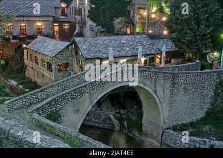 Mostar, Bosnia-Erzegovina – Maggio 2022: La sera il Kriva Ćuprija (ponte storto„) a Mostar. Inscripted come monumento nazionale e UNESC Foto Stock