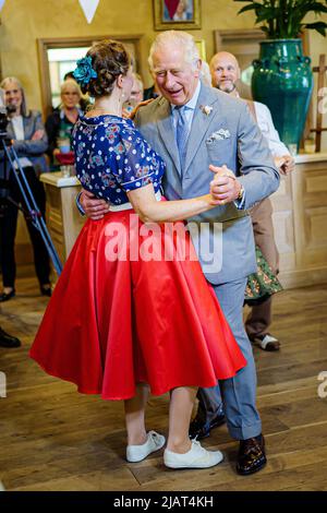 Il Principe di Galles balla con Bridget Tibbs durante una danza del tè giubilare ospitata dalla Fondazione del Principe per celebrare il Giubileo del platino, ad Highgrove vicino a Tetbury, Gloucestershire. Al Principe Carlo si unì Jools Holland, Ruby Turner e Patrick Grant alla celebre danza del tè, una delle tante tenute in tutto il Regno Unito dalla Prince's Foundation, il cui obiettivo è combattere la solitudine e l'isolamento nelle comunità circostanti. Data foto: Martedì 31 maggio 2022. Foto Stock