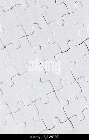 White puzzle. White i pezzi del puzzle sul colore di sfondo. Bianco incompiuto puzzle di pezzi sul colore di sfondo. Foto Stock