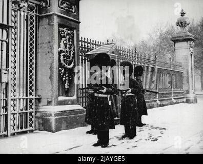 Snowy Relief - in una tempesta di guardie di neve sono sollevati fuori Buckingham Palace questa mattina 29 marzo. Prendere nota dei fucili trasportati in posizione di sicurezza per proteggere la camera dalla neve. Marzo 29, 1952. (Foto di stampa associata). Foto Stock