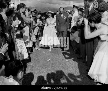 Tutti gli occhi sulla principessa -- la principessa Margaret è il centro di attrazione per una folla ammirante mentre cammina con Colin Calder presidente del Jockey Club della Giamaica, a Knutsford Park, Giamaica, il feb.19. Febbraio 20, 1955. (Foto di stampa associata). Foto Stock