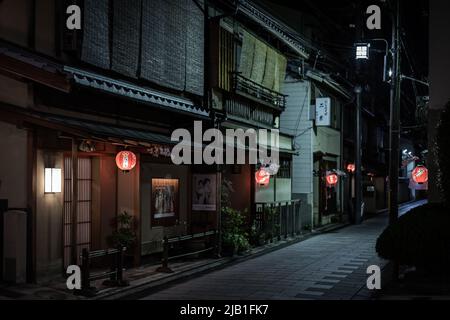 Paesaggio urbano di Miyagawa-cho, uno dei quartieri Hanamachi o geisha di Kyoto, di notte. Ochaya decorata con un ramo di Sakura e lanterna. Foto Stock