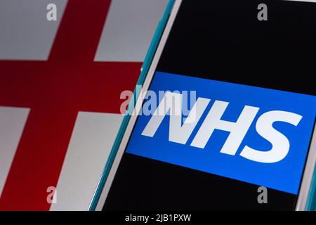 Kumamoto, GIAPPONE - Set 6 2021 : NHS (National Health Service) logo su iPhone sulla bandiera inglese. Esistono 3 sistemi che utilizzano lo stesso nome NHS Foto Stock