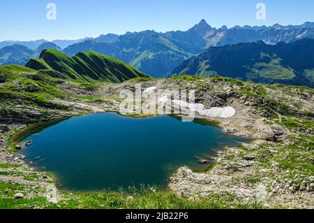 Splendida vista sulle Alpi di Allgäu in una mattinata estiva con Laufbichlsee in primo piano Foto Stock