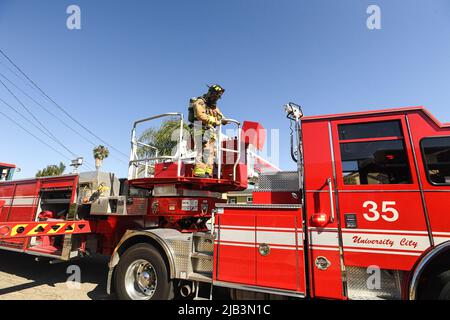 San Diego Fire Rescue Firefighter assicura la catena di sicurezza sul camion 35 Foto Stock