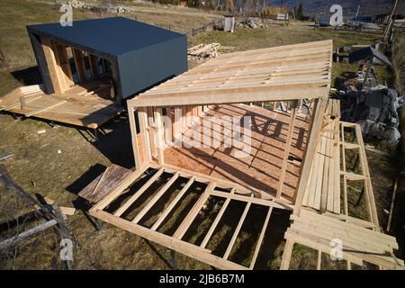 Veduta aerea della casa con struttura in legno su palo di fondazione in costruzione in montagna. Foto Stock