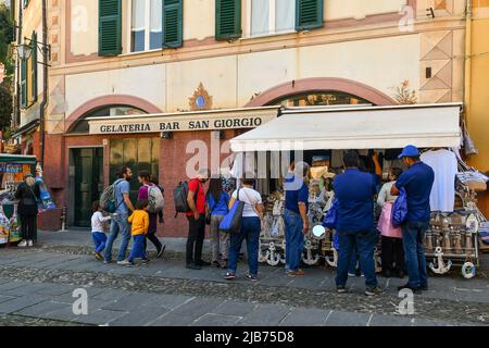 I turisti e i backpackers che si trovano nelle bancarelle della famosa Piazzetta di Portofino, Genova, Liguria, Italia Foto Stock