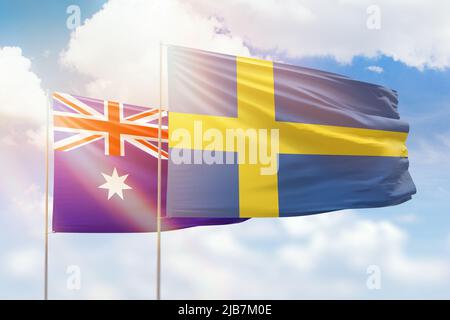 Cielo azzurro soleggiato e bandiere di svezia e australia Foto Stock