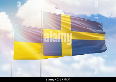 Cielo azzurro soleggiato e bandiere di svezia e ucraina Foto Stock