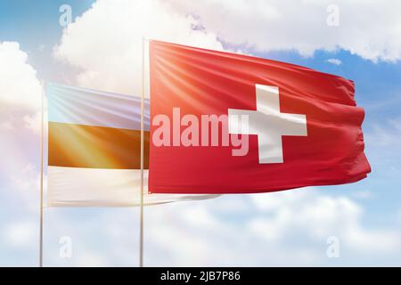 Cielo azzurro soleggiato e bandiere di svizzera ed estonia Foto Stock